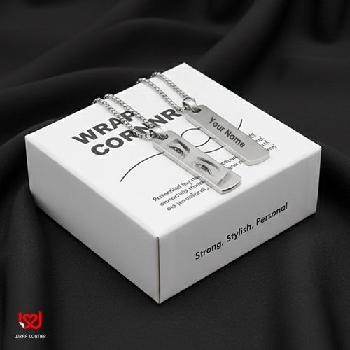 Silver necklace with nameplate on a branded box