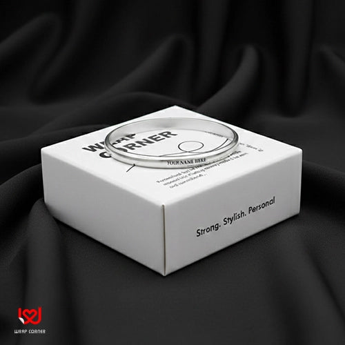 White box with a silver ring inside on a black fabric background